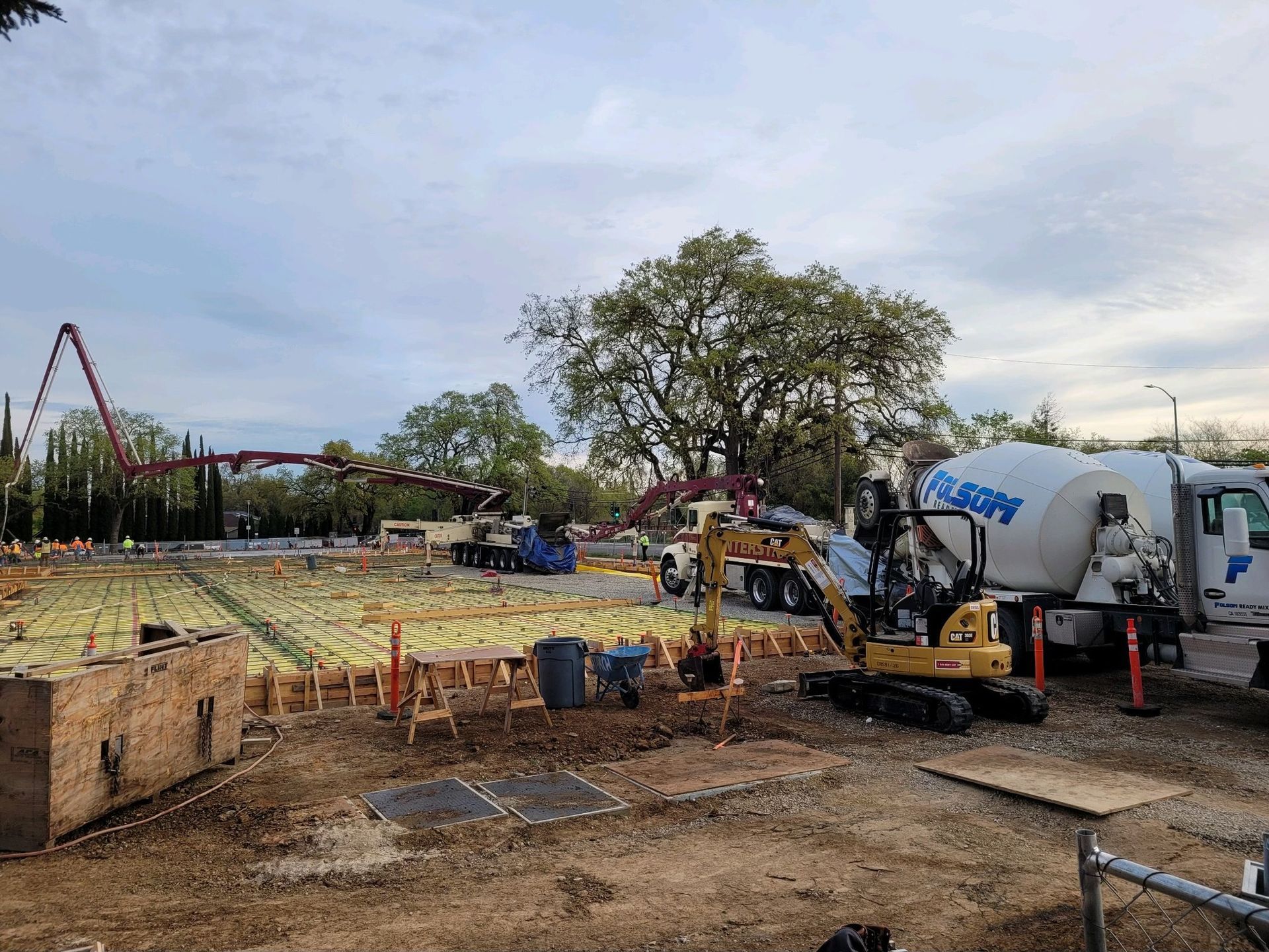 Folsom Ready Mix truck delivering concrete for a commercial project with crews placing and finishing the mix.